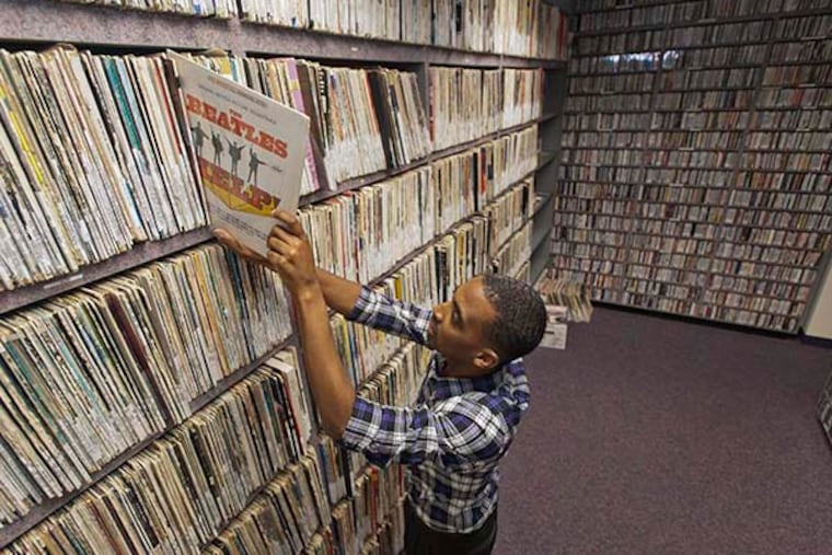 Derek Jones, station manager of Rowan University radio station WGLS, pulls a record from the music library of the station, which is celebrating 50 years on the air in Glassboro, N.J. ( RON TARVER / Staff Photographer )