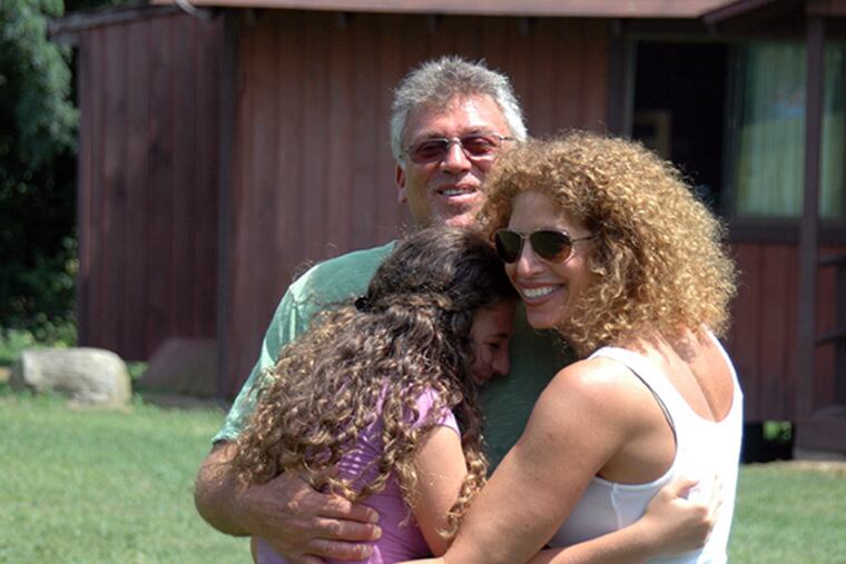 Keenan and Susan Rosen reunite with daughter Dakota, 13, on parents visiting day at Camp Louemma. (Jamie Tibbals photo)