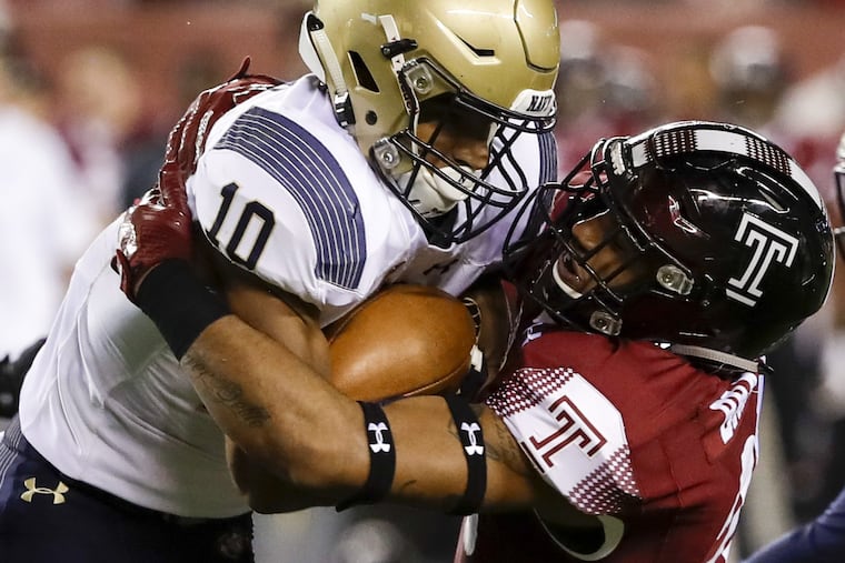 Temple linebacker Shaun Bradley (right) stopping Navy running back Malcolm Perry last season.