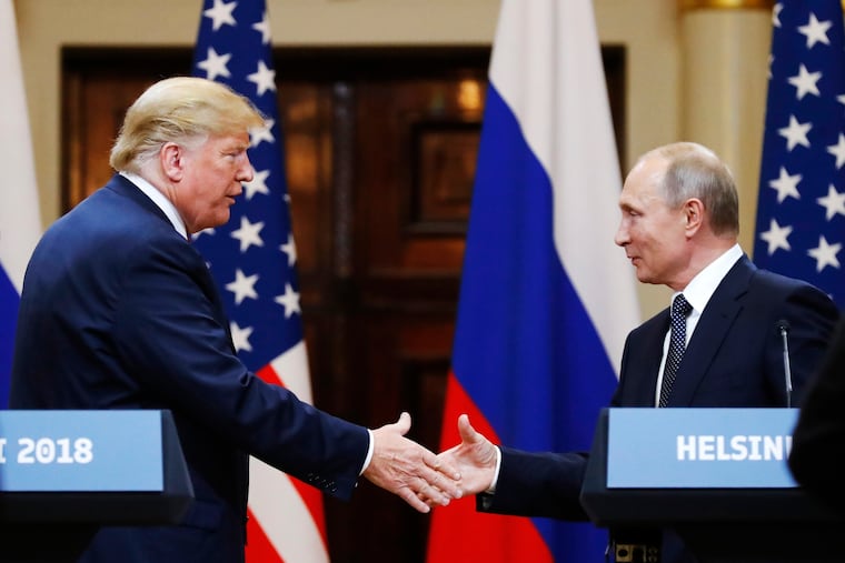 Donald Trump shakes hand with Russian President Vladimir Putin at the end of a news conference after their meeting at the Presidential Palace in Helsinki in 2018. Trump doesn’t care if Putin retakes Ukraine, so long as the president can take credit for a ceasefire, writes Trudy Rubin.