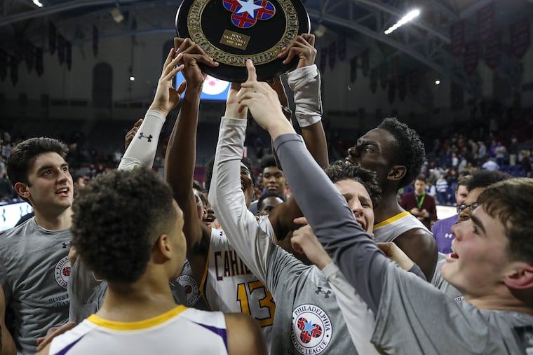 The Roman Catholic basketball team celebrates after beating La Salle for the Catholic League championship.