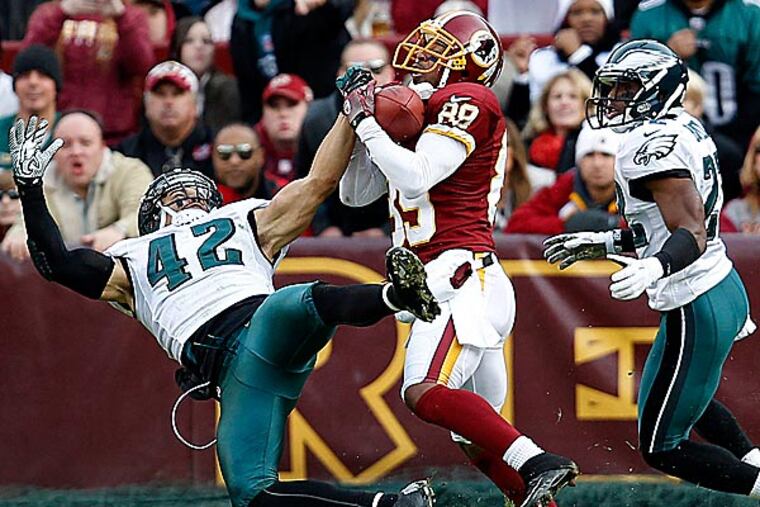 Kurt Coleman and Brandon Boykin can't stop Santana Moss on a touchdown catch in the third quarter. (David Maialetti/Staff Photographer)