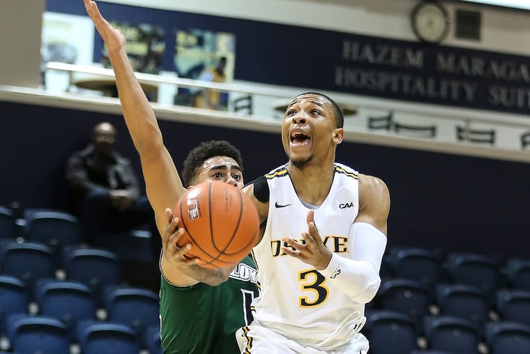 Troy Harper shooting past Loyola's Chuck Champion, a Friends' Central grad, in December.