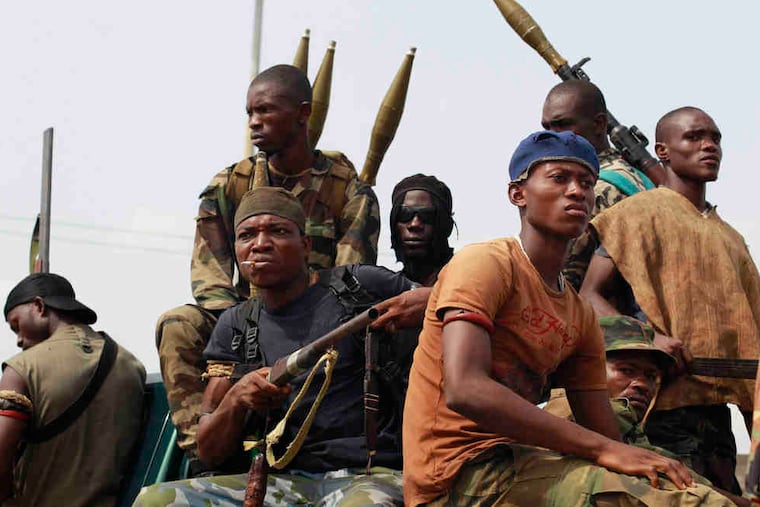 Louise Arbour, left, president of the International Crisis Group, will accept the award. Below, soldiers in Ivory Coast, where ICG helped draw attention to post-election violence.