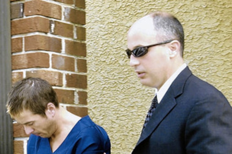 A Pennsylvania state trooper led William F. Smithson into a hearing in September. A Delaware County jury last week convicted Smithson of murdering coworker Jason Shephard.