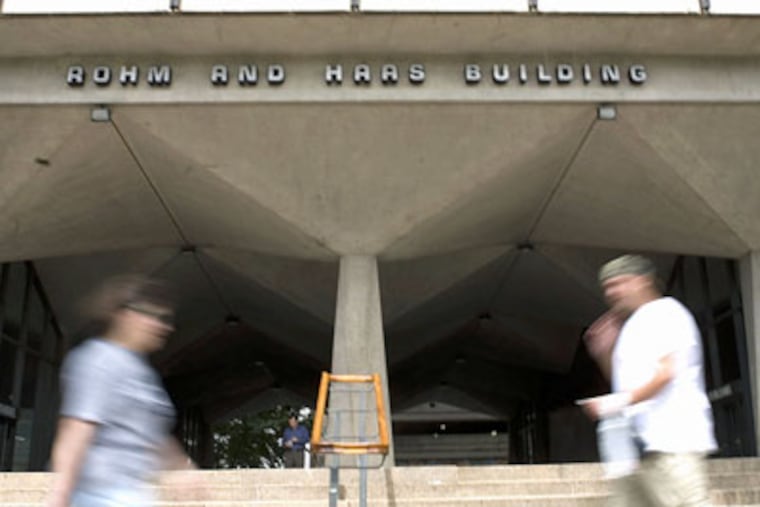 In this 2008 file photo, pedestrians walk near the Rohm and Haas Co. headquarters in Philadelphia. (AP Photo / Justin Maxon, file)