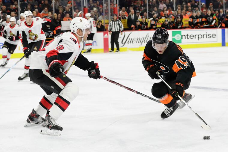 Flyers winger Joel Farabee (right) skates past Ottawa Senators defenseman Dylan DeMelo early last season. He is among 22 forwards who wlil be at training camp Monday.