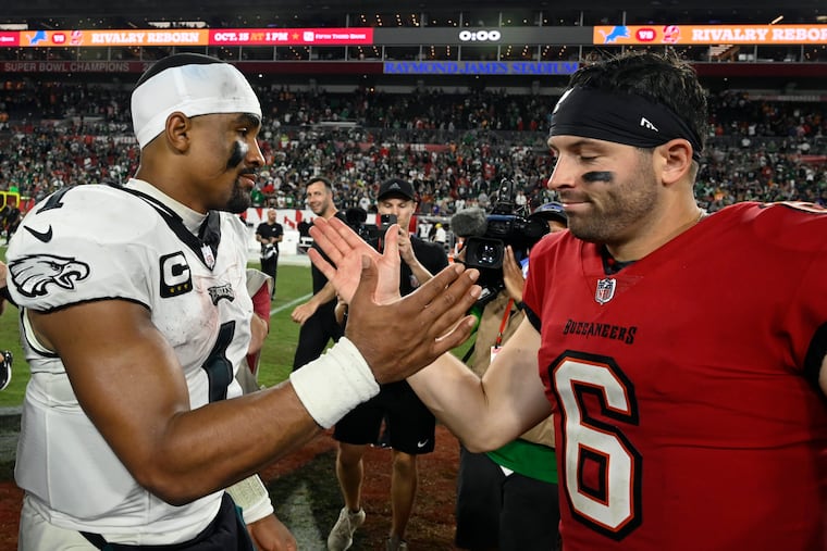 Eagles quarterback Jalen Hurts and the Buccaneers' Baker Mayfield meet after a game on Sept. 25, 2023, in Tampa, Fla.