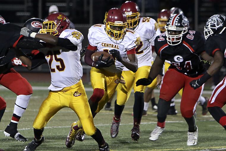 Central's Collin Washington (11) runs the ball during their Public League Class AAAA Semifinal football game against Simon Gratz, Friday Nov. 13 2015, in Philadelphia.