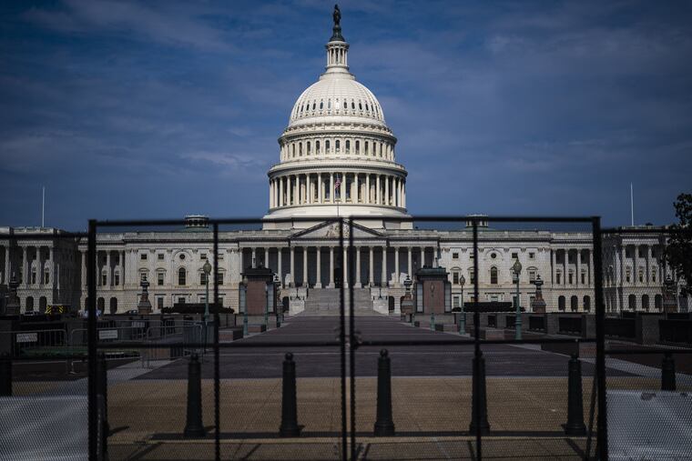 Fencing, erected after the Jan. 6 riot, is seen surrounding the Capitol building in Washington on July 9, 2021.