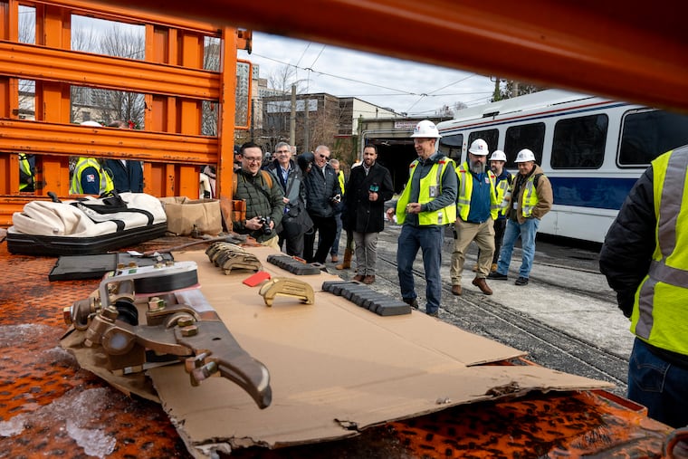 Trolley slider parts are on display in front of the trolley tunnel as Jason Tarlecki, acting SEPTA chief engineer of power, updates reporters in mid-December on repairs to overhead wires. Problems with the sliders, which protect the wires, have led to the tunnel's closure for more than two months.