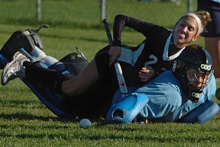 Shawnee goalie Briana Pereira reaches for the ball as Bishop Eustace's Kalie Pistone sits on her back in an Oct. 23 game.