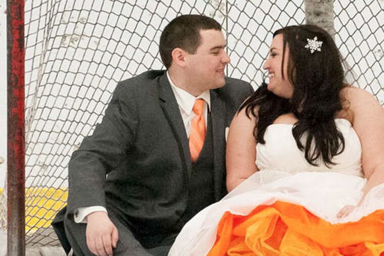 The couple were wed at center ice at Flyers Skate Zone in the Northeast, which is why they are on the ice in the photos. (Chris Hayes Photography)