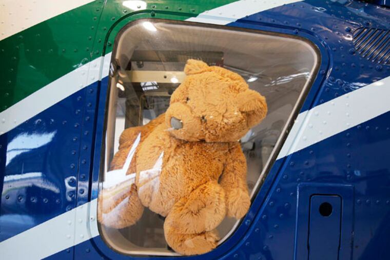 Cook Children's "Teddy Bear" Transport, which was created especially for child patients, flew to Brownwood, Texas, to pick up a newborn baby boy with a heart defect on Tuesday, July 8, 2014. The stuffed bear sits in the window of their helicopter. (David Woo/Dallas Morning News/MCT)