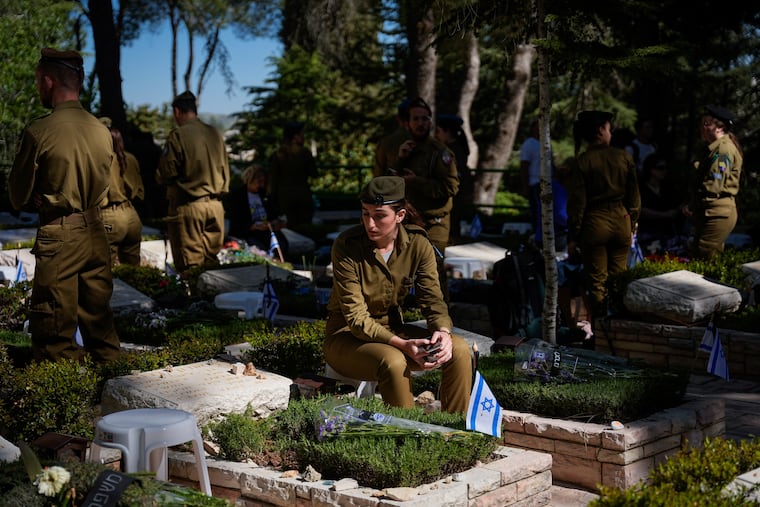 Israeli soldiers and family members of fallen soldiers gather for a ceremony marking Israel's annual Memorial Day at a military cemetery in Jerusalem on Tuesday. Israel marks Memorial Day in remembrance of soldiers who died in the nation's conflicts.
