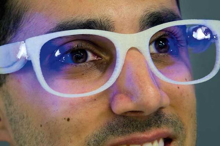 Troy Hudson, 22, a senior at Drexel University, models his Lumiware therapy glasses for people with seasonal affect disorder. Hudson's hometown is Runnemede, NJ. Photo taken May 27, 2014 at Drexel's URBN Center. ( CLEM MURRAY / Staff Photographer )