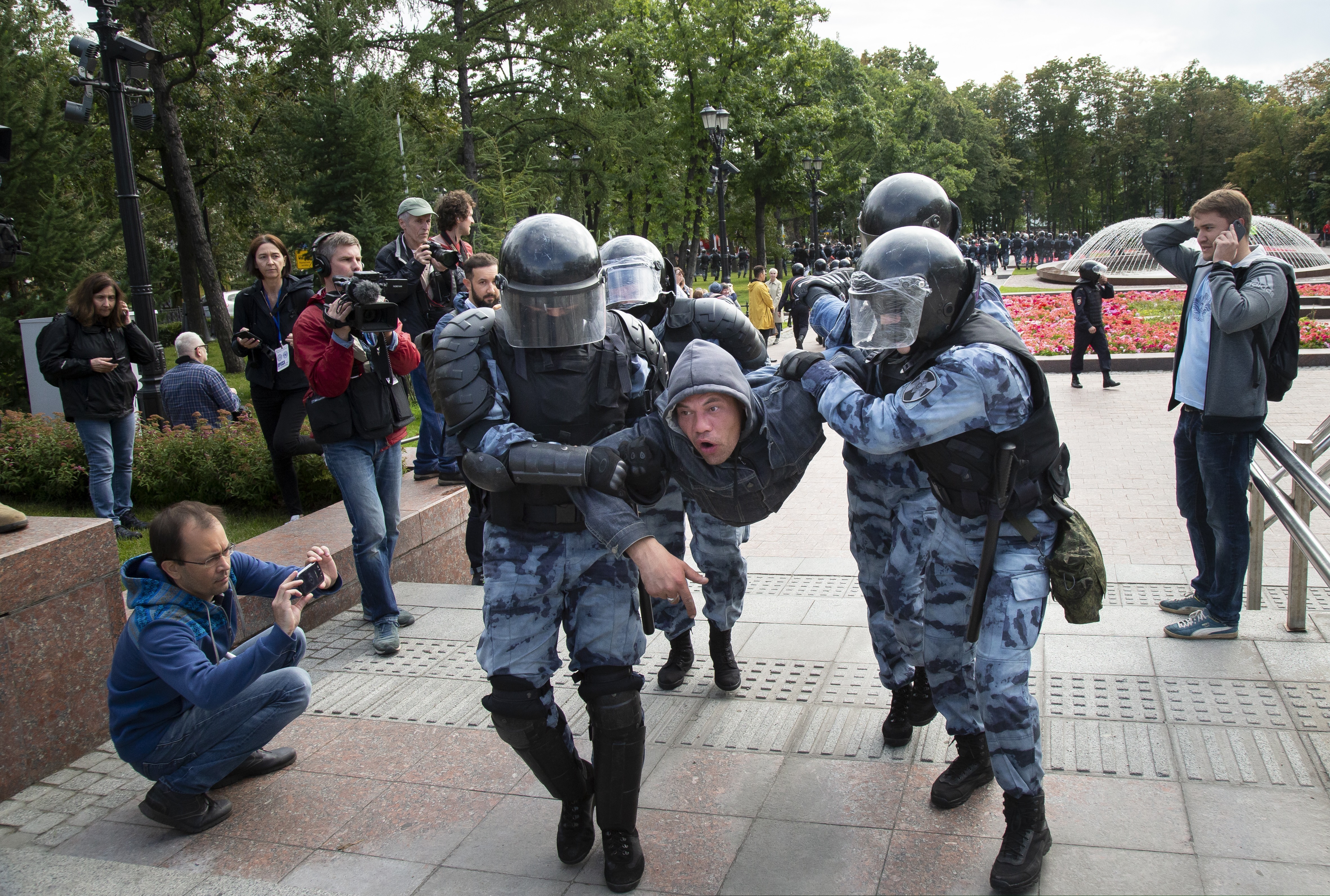 Police officers detain a protestor, during an unsanctioned rally in the center of Moscow, Russia, Saturday, Aug. 3, 2019. Moscow police detained more than 300 people Saturday who are protesting the exclusion of some independent and opposition candidates from the city council ballot, a monitoring group said.