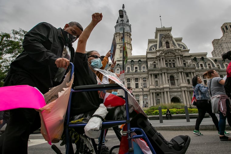 Eva and Frankie Diaz, parents of Frankie Diaz Jr., a young man who died in custody at the Philadelphia Detention Center. The family, friends and their supporters marched on the streets of Center City Thursday.