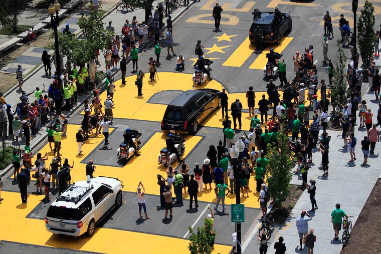 The hearse carrying the late Rep. John Lewis, D-Ga., moves along a section of 16th Street that's been renamed Black Lives Matter Plaza in Washington on Monday.