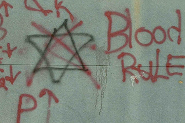 Graffiti in Irvington, N.J. Authorities say the six-point star, a Crips symbol, is crossed out by a Bloods member in a sign of disrespect.