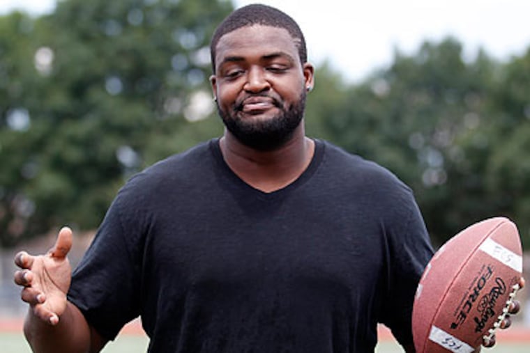 Demetress Bell welcomed kids to his football camp at Northeast High School on Tuesday. (Yong Kim/Staff Photographer)