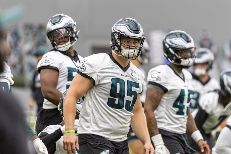 Eagles defensive tackle Ty Robinson, (center) warms up during OTA practice on Wednesday.