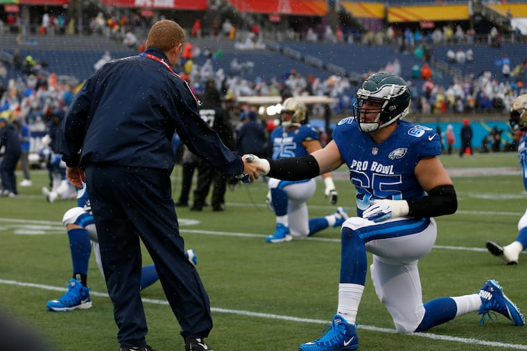 Former Cowboys head coach Jason Garrett, who coached the NFC last year, greets Eagles offensive lineman Lane Johnson. Johnson, selected as an alternate this year, will be attending his third Pro Bowl.