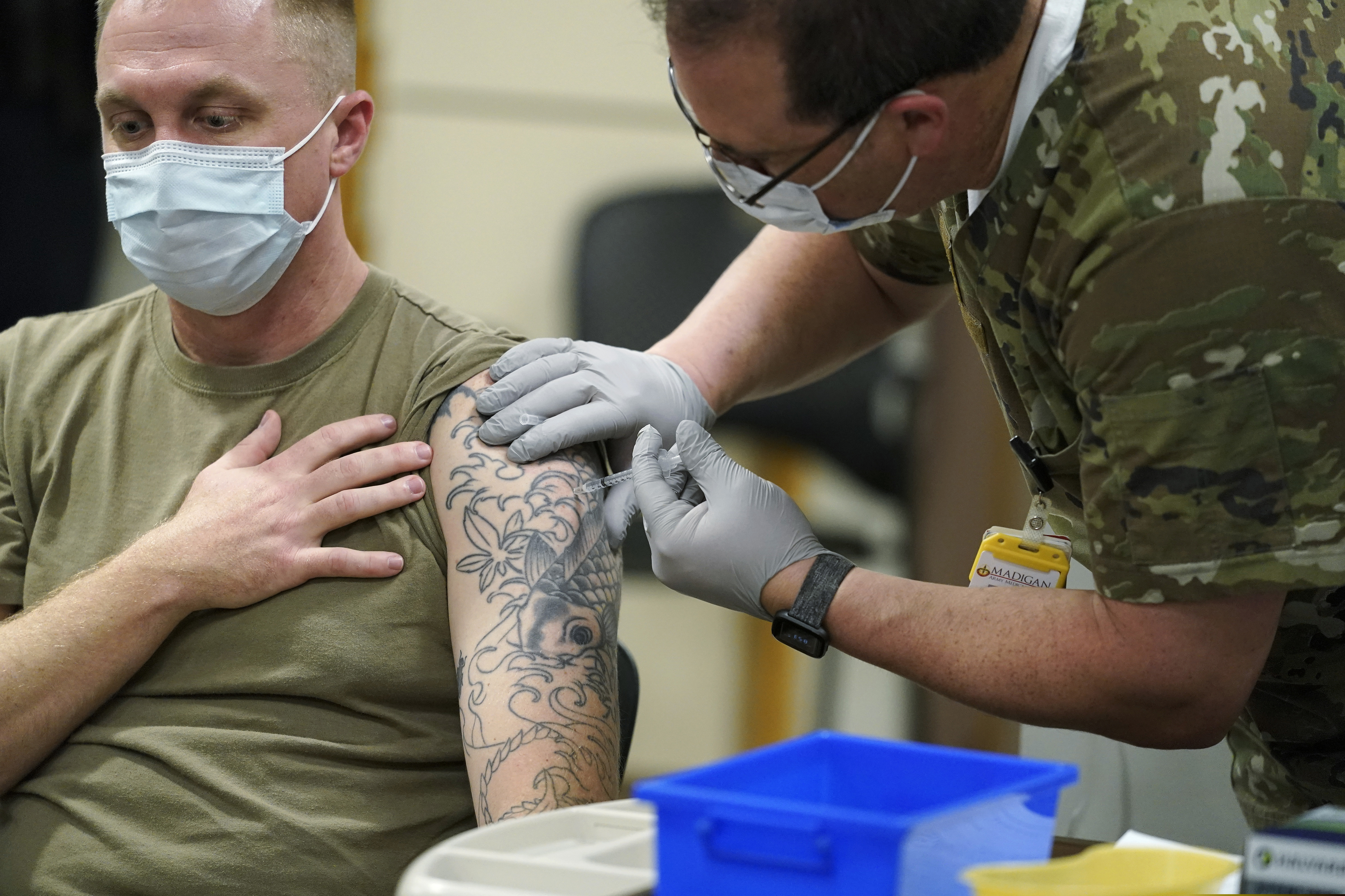 Staff Sgt. Travis Snyder receives the first dose of the Pfizer COVID-19 vaccine given at Madigan Army Medical Center at Joint Base Lewis-McChord in Washington state.