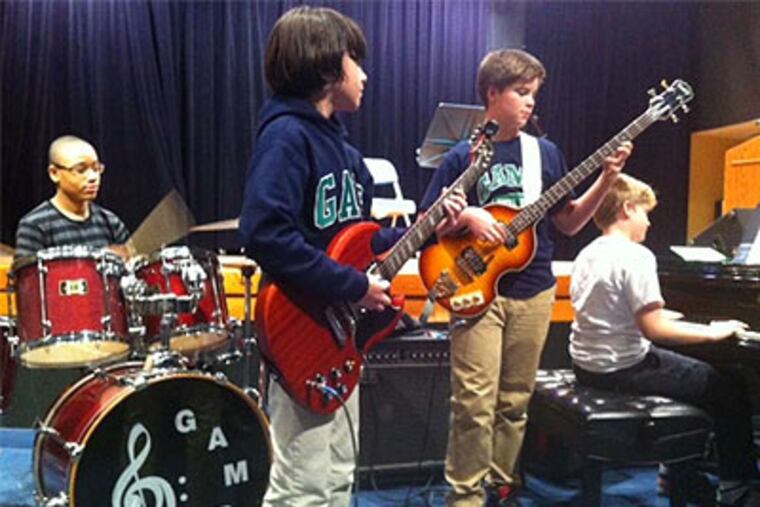 A GAMP middle school ensemble, above, performs at a rally to save busing at the city's music magnet school. Right, GAMP eighth grader Georgia Puhl dances. (Kristen A. Graham / Staff)