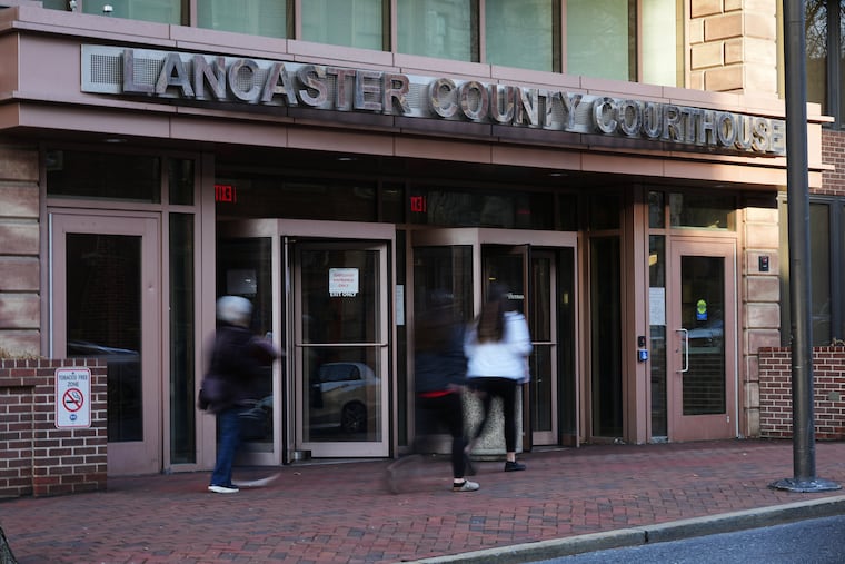 People enter the Lancaster County Courthouse in Lancaster, Pa., Wednesday, March 25, 2026. (AP Photo/Matt Rourke)