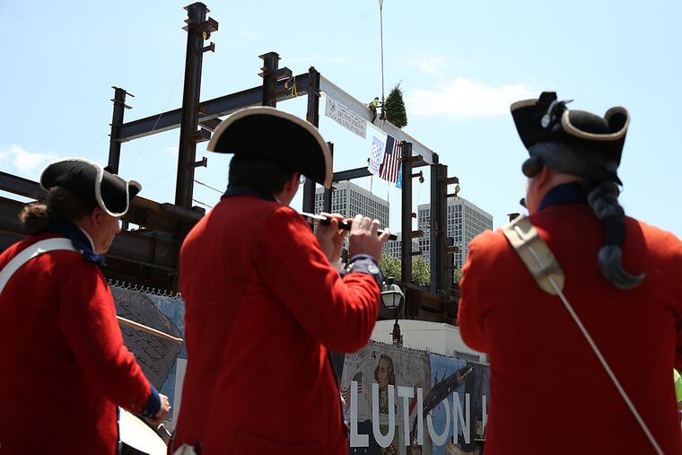 Members of the fife and drum corps of the Old Barracks of Trenton salute the topping off of the Museum of the American Revolution at Third and Chestnut Streets. The museum is to open in spring 2017. (DAVID MAIALETTI / Staff Photographer)