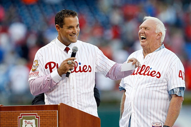 Former Phillies' Pat Burrell laughs with former Phillies Manager Charlie Manuel during Burrell's Phillies Wall of Fame induction ceremony.
