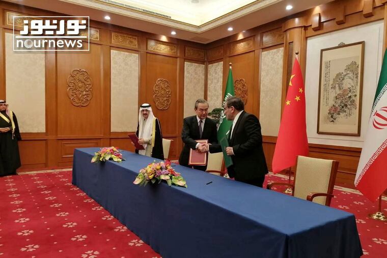 Secretary of Iran's Supreme National Security Council Ali Shamkhani (right) shakes hands with China's most senior diplomat Wang Yi, as Saudi Arabia's National Security Adviser Musaad bin Mohammed al-Aiban looks on during a ceremony Friday.