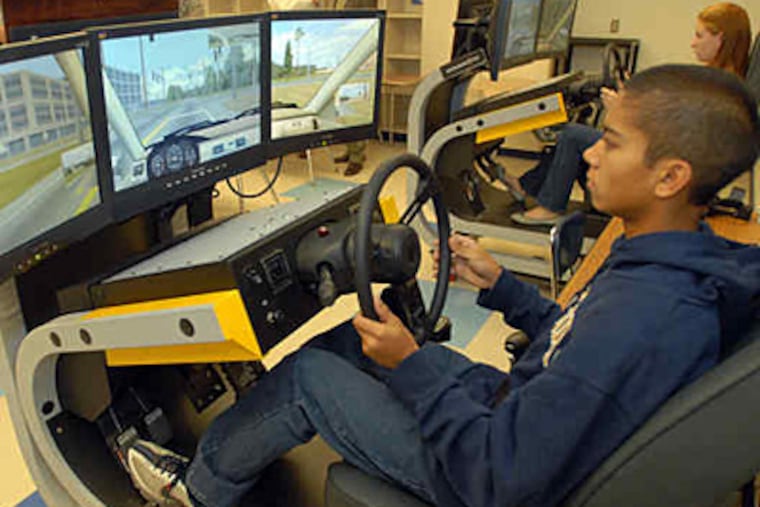 Shawnee High sophomore Chris Stegmuller , 15, practices driving on one of the simulators donated by Patricia and Dan Fitzpatrick. Their son Ryan, 18, died in the crash of the SUV he was driving. (Ron Tarver / Staff)