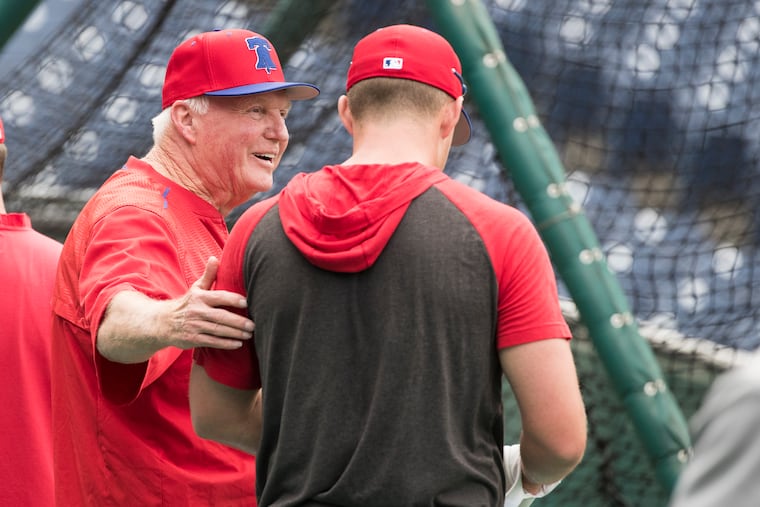 Charlie Manuel, hitting genius, talks with Rhys Hoskins during batting practice at Citizens Bank Park on Aug. 14, 2019.