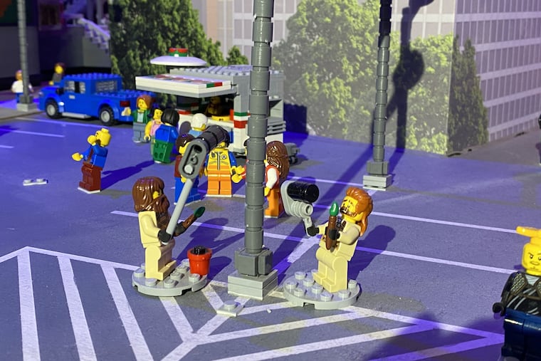 Lego minifigures grease a tiny pole to prepare for celebrations ahead of Sunday's Super Bowl in Phoenix, Arizona. The Legoland Discovery Center in Plymouth Meeting has a wager with the Kansas City location.