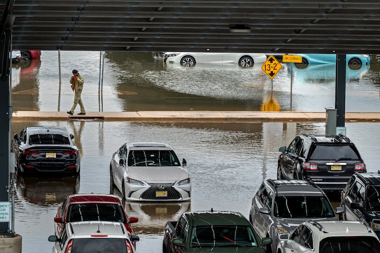 The parking lot of the Ferry Avenue PATCO station in Camden is flooded by rains last month in what has become a familiar sequence. More downpours are expected Thursday.