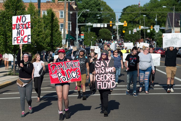Protesters march through the streets of Mount Vernon, Ohio. A group of college students organized the event to stand in solidarity with other protests across the nation spurred by the death of Floyd George in Minneapolis and of other African Americans.