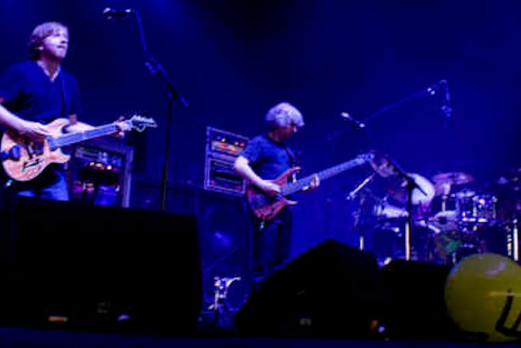 On stage for a 23-song set: (from left) Trey Anastasio, Mike Gordon on bass, Jon Fishman on drums. Keyboardist Page McConnell is not visible. If it felt right, they went the distance on improv. "Sand" alone clocked in at 22 minutes.