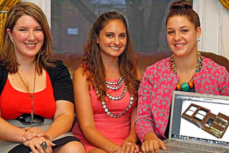 Three of the artists (from left) Emi Savacool, Maricha Genovese, and Kaitlin Kerr with a picture of the memory box they created for comedian Patton Oswalt. (Akira Suwa/Staff)