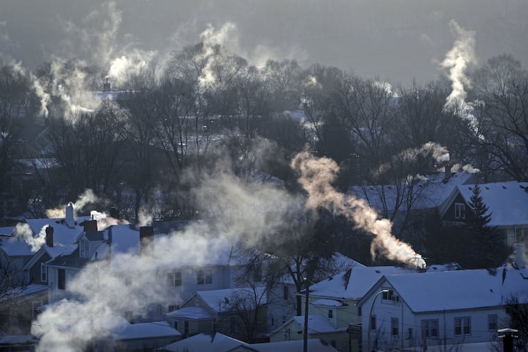 FILE- In this Wednesday Jan. 30, 2019, file photo smoke rises from the chimneys of homes in St. Paul, Minn. While the polar vortex is driving up demand for natural gas, it isn’t doing the same for the price. The massive weather system is blanketing much of the Midwest and Northeast in a deep freeze, and demand for natural gas is spiking as homeowners crank up the heat to stay warm.
Yet natural gas prices have fallen this week and are in the throes of a two-month skid. (Brian Peterson/Star Tribune via AP, File)