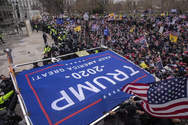 A “Trump 2020” banner is carried as demonstrators at the U.S. Capitol on Jan. 6, 2021.