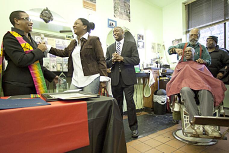 Dee Bailey-Gittens of Each One Teach Consultants with award-winner Alyssa Wilds. Shop owner Russell Farmer gives Carlton Wilson a trim. (David M Warren / Staff Photographer)