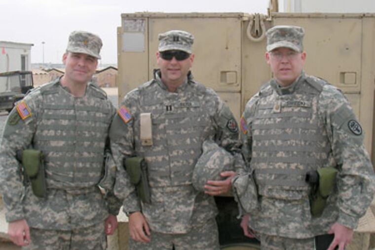 Dr. John Pryor (center), a surgeon at the University of Pennsylvania Trauma Center, is flanked by colleagues from the 334th Combat Support Hospital. (From 2006)