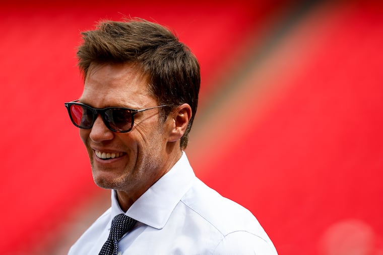 Tom Brady stands on the field before the Eagles game against the Kansas City Chiefs at Arrowhead Stadium on Sunday. Brady was in the booth with Kevin Burkhardt, just like he was for Super Bowl LIX.