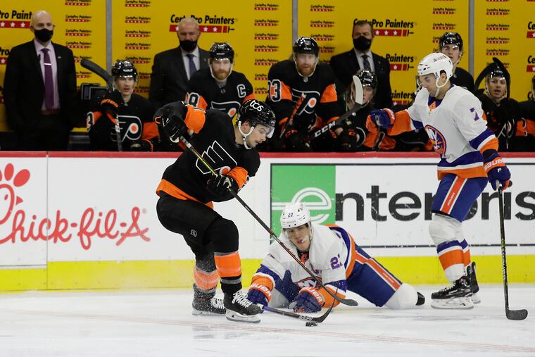 The Flyers' Scott Laughton skated with the puck past New York Islanders left winger Anders Lee (center) and right winger Jordan Eberle earlier this season. The Flyers won in overtime, 4-3. The teams will meet Thursday in Uniondale, N.Y.