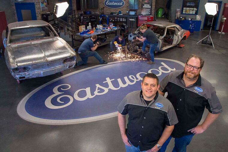 Nick Capinski (left), director of content marketing, and Martin Bispels, chief sales and marketing officer for Eastwood, pose for a portrait October 6, 2016 while staffers in the background prepare to do a video segment on restoring a 1967 Camera for social media and the eastwood.com internet site.