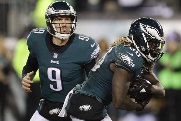 Eagles’ quarterback Nick Foles (left) hands the ball off to running back Jay Ajayi. Foles has used RPO’s, where he has the option to hand the ball off or take it and throw it, with great success during the playoffs.