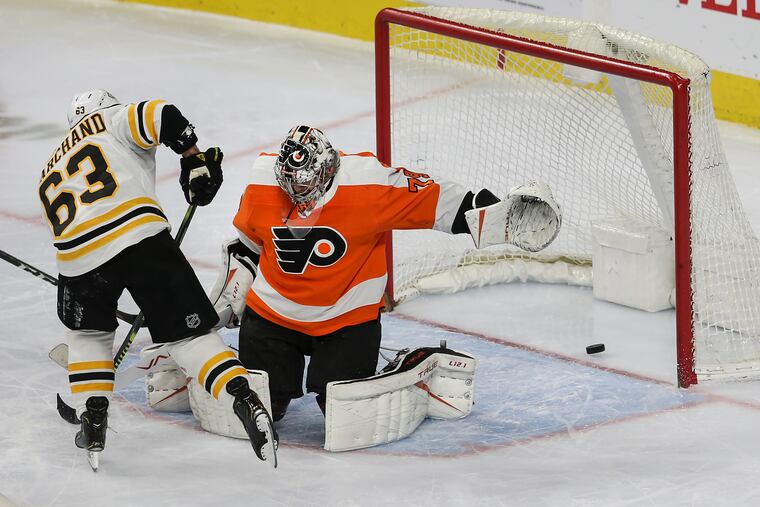Flyers' goalie Carter Hart can't stop the Bruins' Brad Marchand, who scores a shorthanded goal to give Boston a 3-2 third-period lead Tuesday. Boston won, 4-2.