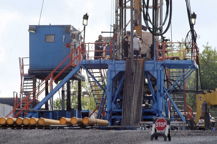 In this June 25, 2012 file photo, a crew works on a gas drilling rig at a well site for shale based natural gas in Zelienople, Pa.